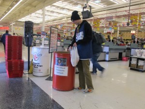 Kaleb Mebust, 20 year old student at the University of Nevada Reno, donates canned goods for the Evelyn Mount Community Outreach Program at Sac N Save.